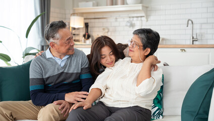 Asian daughter shared a moment of joy with her parent, engaging in a lively conversation that brought laughter and smiles. They embraced in a warm hug, cherishing the special bond between them