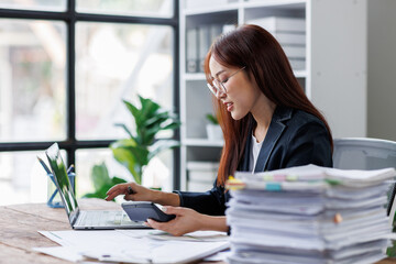 Business financing accounting banking concept. Business woman hand doing finances and calculate on desk about cost at home office. Woman working on desk with using calculator, finance accounting.
