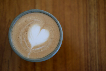 Top view latte art coffee on wood background