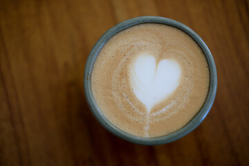Top view latte art coffee on wood background
