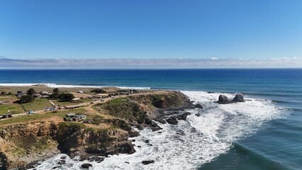 Aerial view of coastal cliffs and ocean waves.