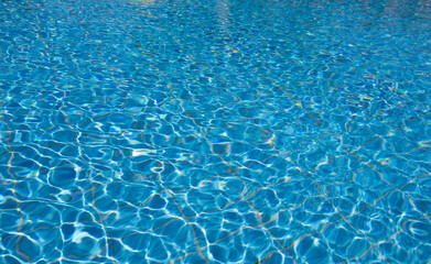 Water in swimming pool rippled water detail background.  Blue in the water in the swimming pool.
