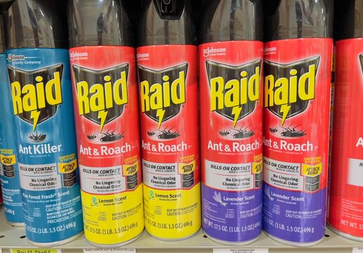 Cans of Raid brand Ant and Roach spray on shelf.