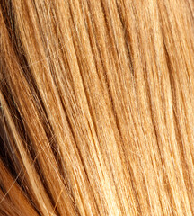 A close up of a woman's hair with a light brown color