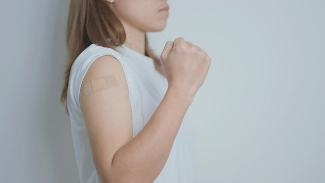 Woman with bandage after receiving vaccine. Vaccination and Immunization for Influenza, HPV, Zoster, IPD, DTP or Diphtheria, Tetanus and Pertussis, MMR, Hepatitis B, Covid  and Varicella vaccine