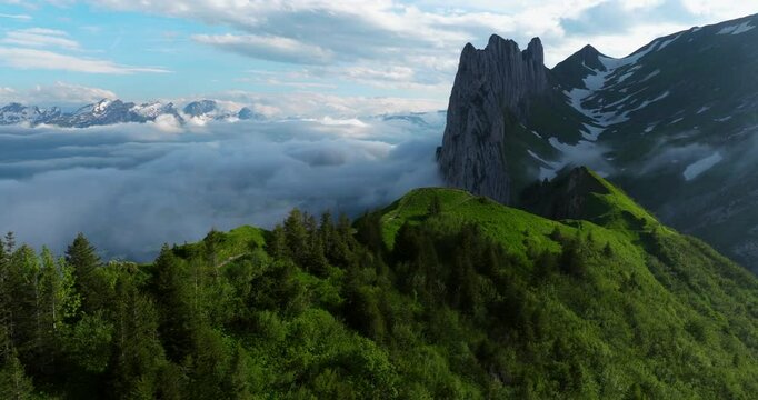 Hiking Trail On Saxer Lucke With Sea Of Clouds Surrounding Mountain Peak. Appenzell Alps In Switzerland. orbiting drone shot