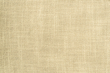 Jute hessian sackcloth woven burlap texture background in yellow beige cream color