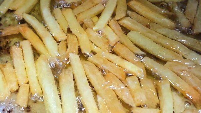 Close-up picture of french fries potato chips being fried