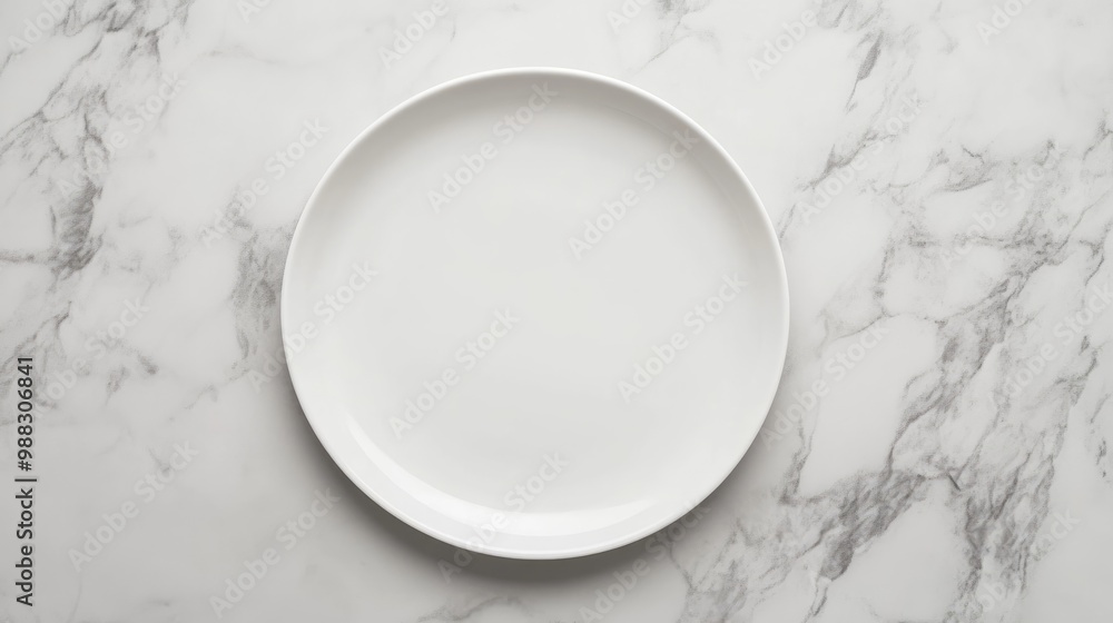 Poster empty white round plate displayed on a marble surface from a top view