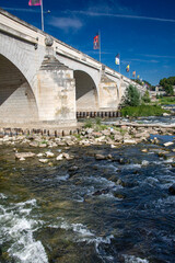 Bridge over Loire river at Tours with water flowing over rocks