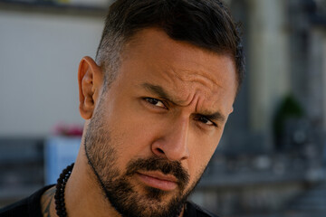 Close up portrait of the handsome man. A Hipster guy model headshot. Male face. Hispanic handsome man. Confident male model. Man looking proud. Closeup face of attractive man. Elegant guy.