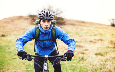 Active man on bike in the middle of beautiful nature, early autumn morning. Concept of healthy lifestyle.