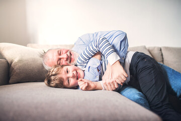 Grandfather spending time with grandson, taking care of him while parents are at work. Having fun.