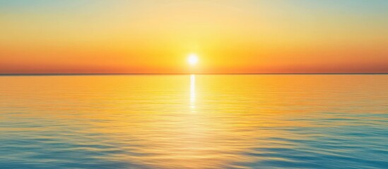 Obraz premium Stunning Golden Sunset Over Calm Ocean Waters with Clear Sky and Vibrant Colors
