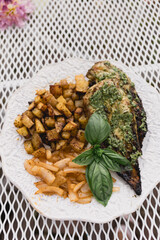 Grilled chicken with homemade pesto, roasted potatoes, and onions