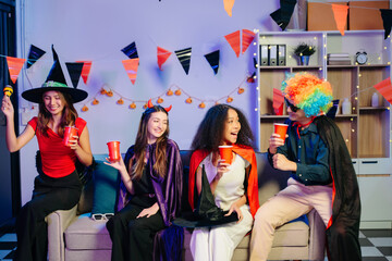 Joyful office Halloween party with coworkers in costumes, celebrating with drinks and laughter, fostering teamwork