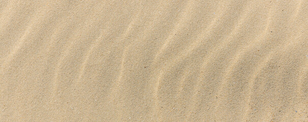 Sand texture. Sandy beach for background. Top view. Natural sand stone texture background. sand on the beach as background. Wavy sand background for summer designs.