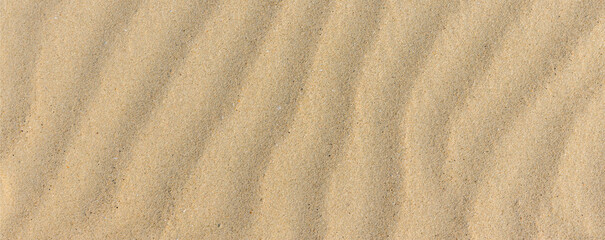 Sand texture. Sandy beach for background. Top view. Natural sand stone texture background. sand on the beach as background. Wavy sand background for summer designs.