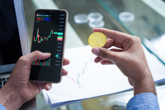 Indian crypto trader usie smart phone to check market price of bitcoin, .Cryptocurrency, Digital asset, Decentrized. Risky Investment, Cyber scam. Online fraud. Anonymous