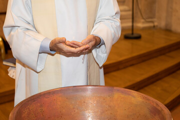 Newborn baby baptism in holy water for infant bathe in the font sacrament god priest baptize