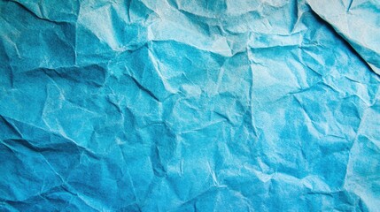 Obraz premium This blue crumpled paper texture background provides a unique and calming aesthetic, ideal for creative and digital applications