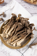dried lyophyllum decastes on wooden table.