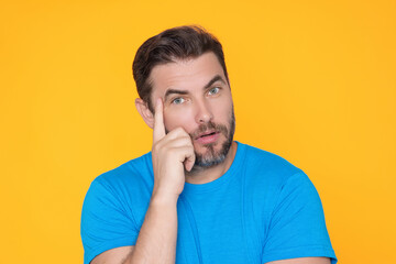 Thinking concept. Portrait of focused smart and creative man, holding fingers cheek, with...