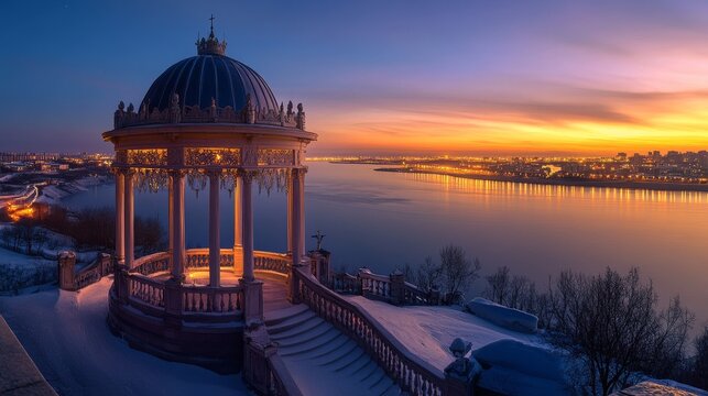 The Blagoveshchensk City Rotunda in Russia shines in the sunset with its clear dome and balustrade, while the city of Heihe, China, rises in the distance across the Amur River.