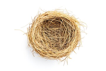 Obraz premium A bird's nest made of branches and blades of grass is placed on a white background.