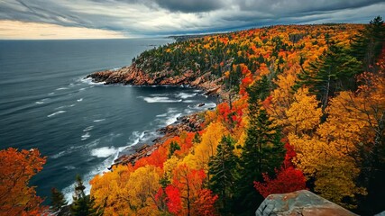 Autumn colors at the coastal cliffs of Acadia National Park in Maine under a moody sky
