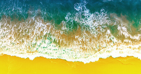Beach view from drone. Blue ocean wave on sandy beach. Sand beach aerial, top view of a beautiful sandy beach. Top view of summer sea waves. Blue sea water in sunny day. Sea background.