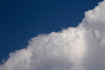 white fluffy cloud against blue sky