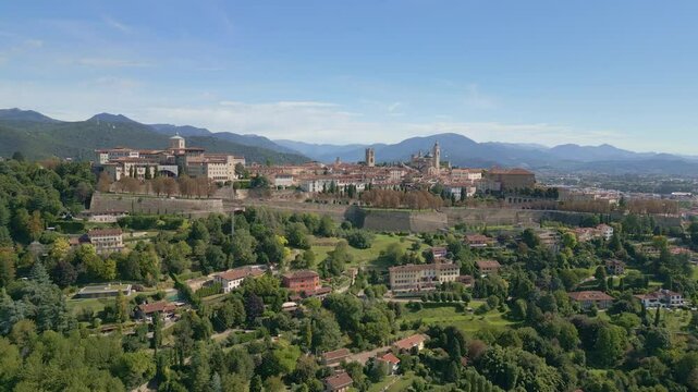 Orbit of to the Old city of Bergamo Alta on the green hills, near Orio al Serio Airport during, A beautiful sunny day