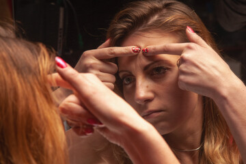 Portrait of woman with skin problem looking at mirror. Dermatology, rosacea dermatitis, allergic...