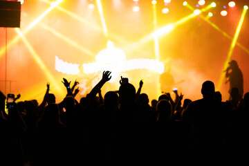 Crowd at concert and colorful stage lights.