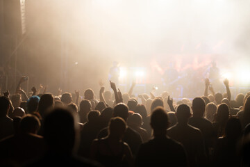 Crowd at concert and blurred stage lights.