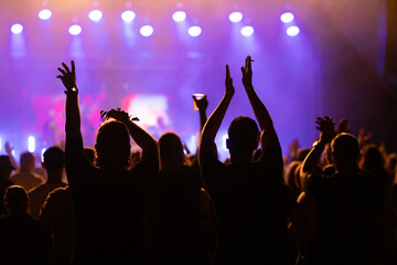 Crowd at concert and blurred stage lights.