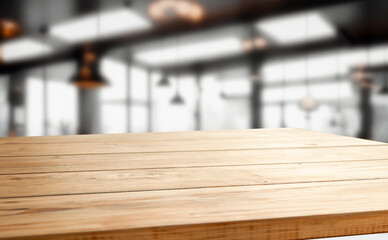 A wooden table top with a blurred background of a cafe.