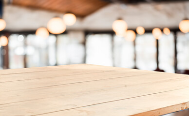 Empty wooden table with a blurred cafe background, perfect for showcasing products or branding.