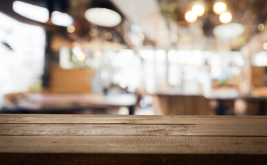 Wooden table top with a blurred background of a cafe or restaurant.
