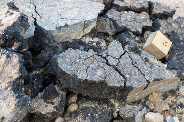 A wooden block with the letter b is on a pile of rocks