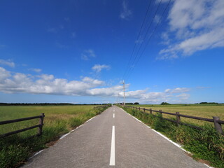 a road under the blue sky