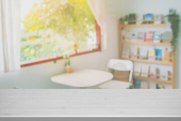 Wooden top table with abstract blur interior coffee shop or cafe for background. Restaurant interior banner, Hospital and clinic blurry. Blurred windows green on outdoor and view of light living room.