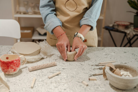 Potter molding clay into shape at workshop