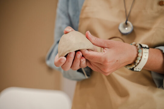Potter sculpting clay in ceramics workshop