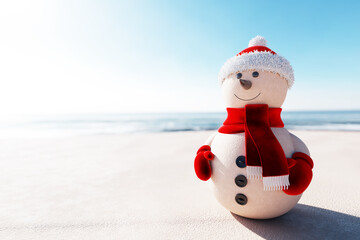 Christmas sandy snowman in Santa Claus outfit on the beach