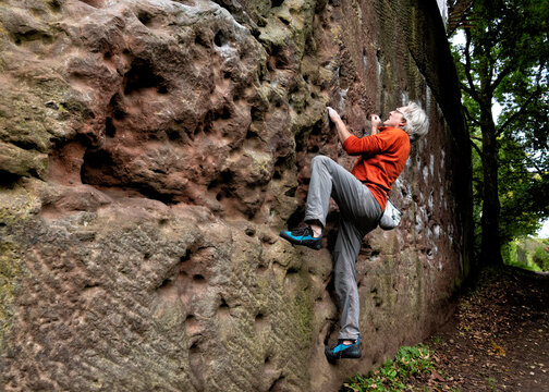 Mature climber climbing Pex Hill in England