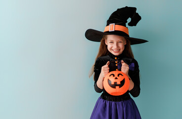 girl in witch costume with Halloween pumpkin