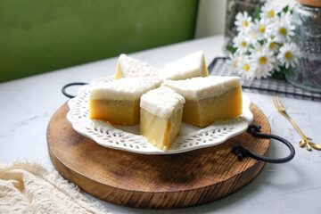 Kuih Talam Pisang, a steamed dessert made with banana and rice flour, featuring a soft, layered texture and sweet, creamy flavor.