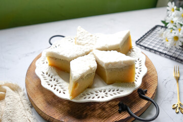 Kuih Talam Pisang, a steamed dessert made with banana and rice flour, featuring a soft, layered texture and sweet, creamy flavor.
